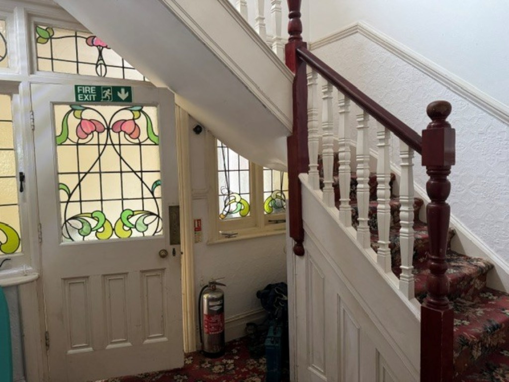 Lot: 87 - FREEHOLD DETACHED FORMER GUEST HOUSE ARRANGED AS FOUR FLATS ON GOOD SIZE PLOT WITH PARKING - View of the stairs and front door